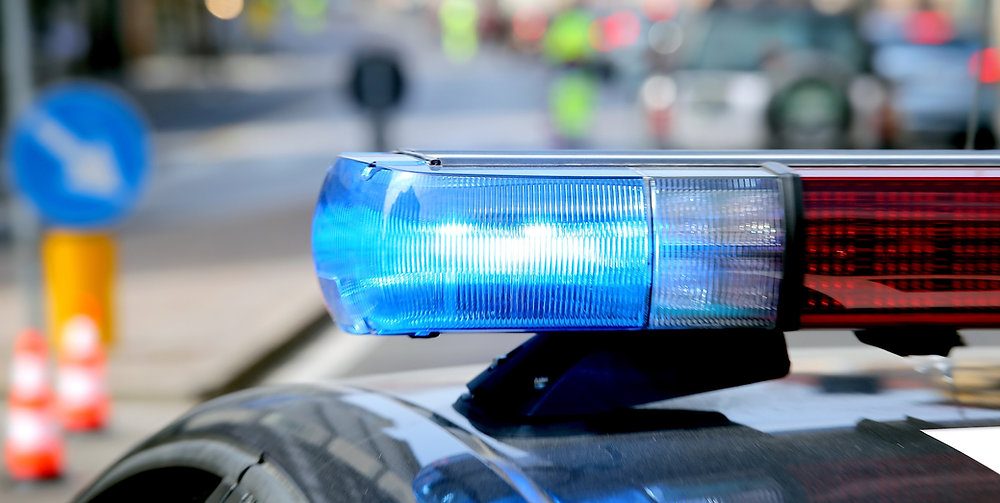 Who contacts the lawyer to request the defense of a detainee at a police precinct in Spain?